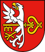 Obraz przedstawia czerwone tło z połową orła i żółtym kluczem